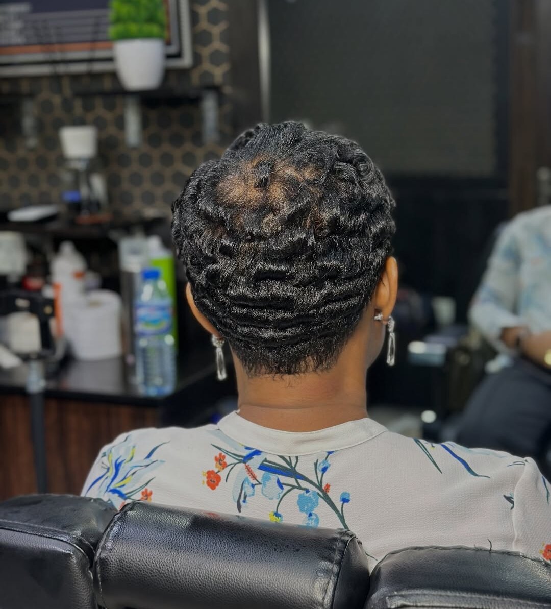 Back view of a short pixie cut set in glossy finger waves