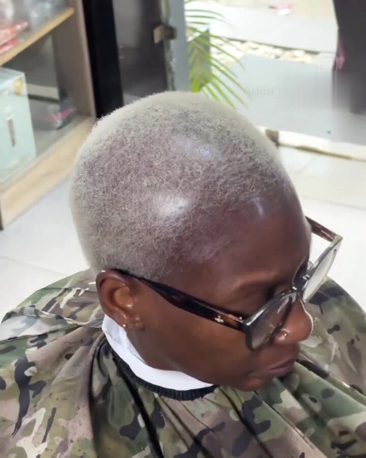A platinum silver short crop on a client wearing glasses